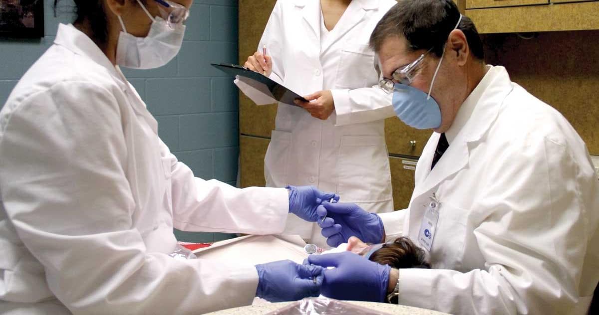 Dental assisting student treating a patient