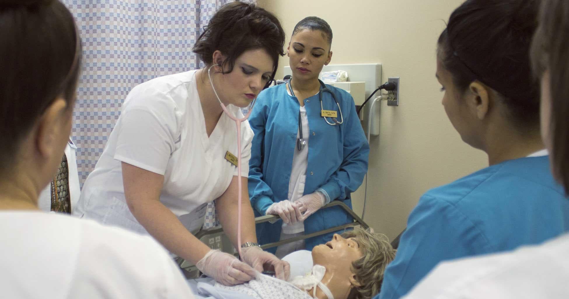 Practical nursing students training in the lab